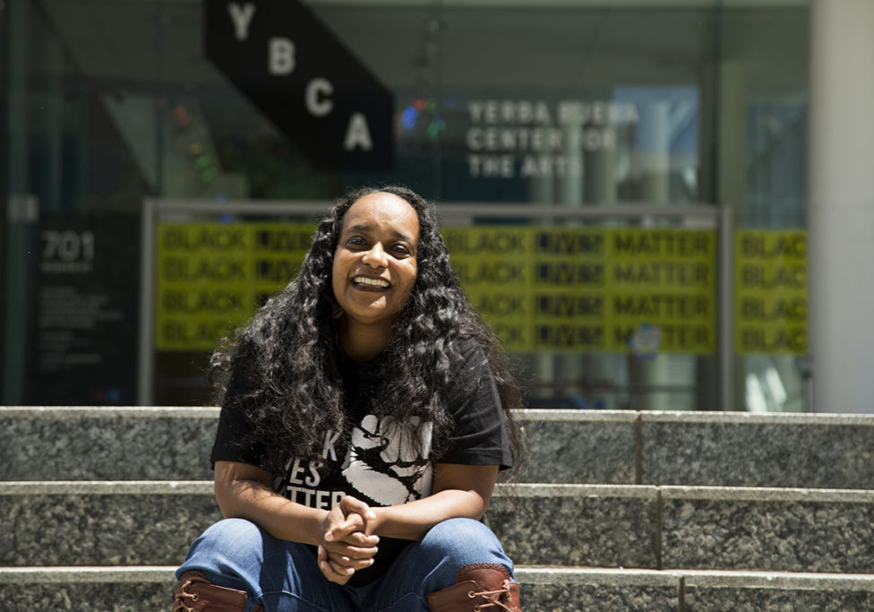 Ericka Scott, an art curator and fellow at the Yerba Buena Center for the Arts, sits outside the center on Tuesday, June 30, 2020. (Kevin N. Hume/S.F. Examiner)