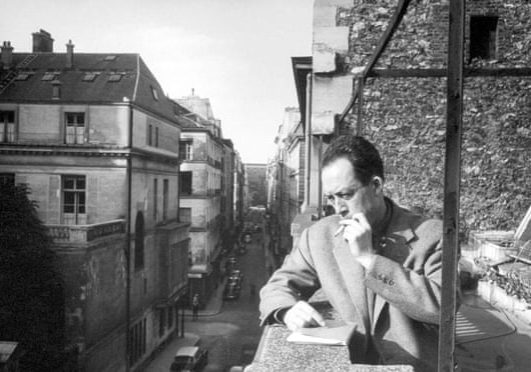 Albert Camus on balcony
